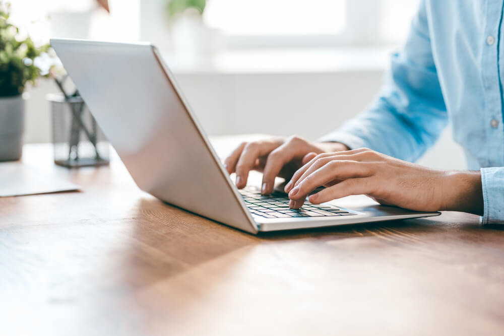 A person typing on a laptop