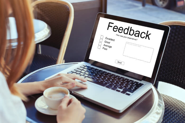 A person on a laptop using negative reviews to advantage