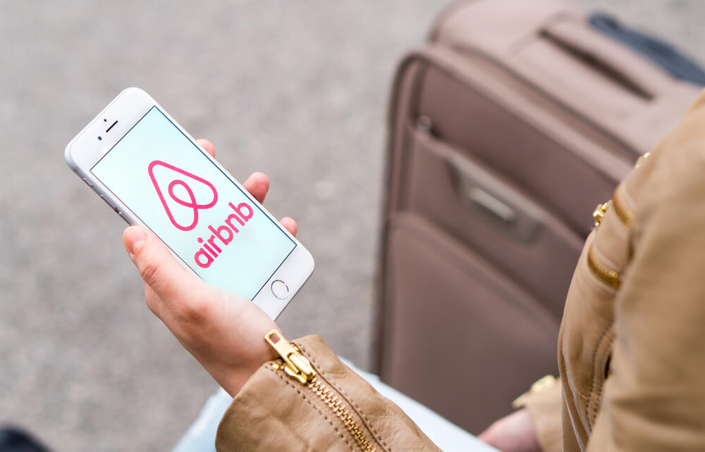 Woman opening the Airbnb app