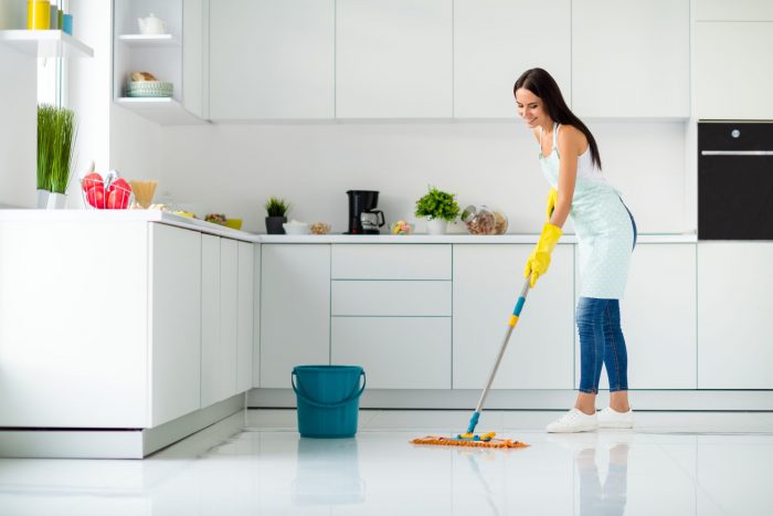 Woman cleaning according to vacation rental cleaning checklists
